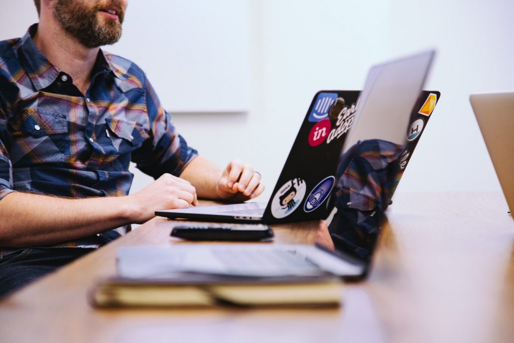 Man on the computer in a meeting.