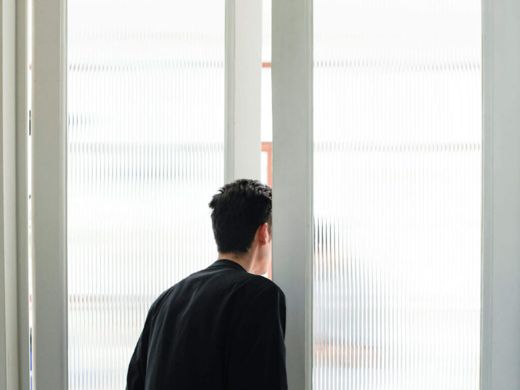 Man looking out door