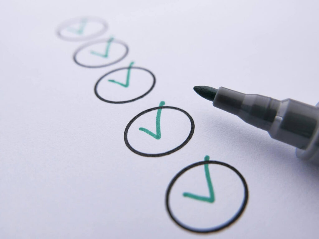 Pen and paper with checkmarks